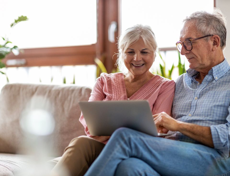 Two grandparents looking at a computer